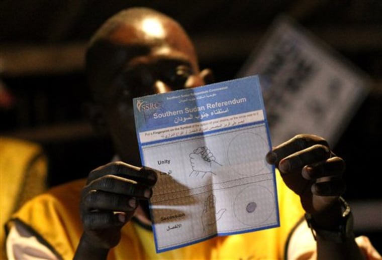 An election official shows a pro independence ballot as votes are tallied at polling station in Juba, South Sudan, on Saturday. Results began trickling in immediately after polls closed Saturday evening. Almost everyone expects the south to vote overwhelmingly to break away from the north, cleaving one of Africa's larger nations in two. 